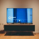 black flat screen tv on brown wooden tv rack