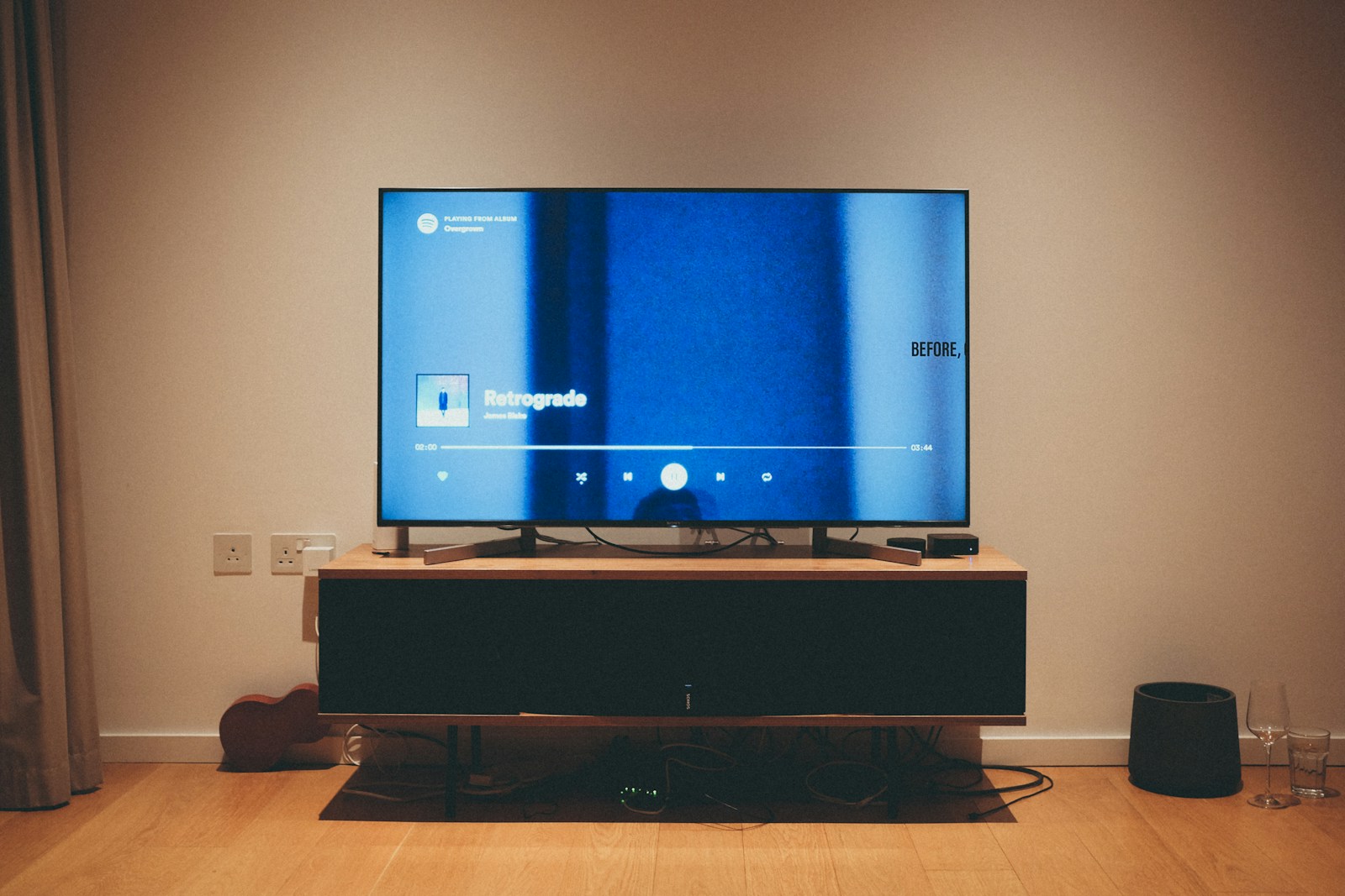 black flat screen tv on brown wooden tv rack