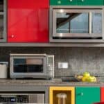 silver microwave oven on black marble counter top