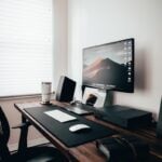 desktop turned on near window