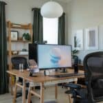a desk with a computer and chair in a room