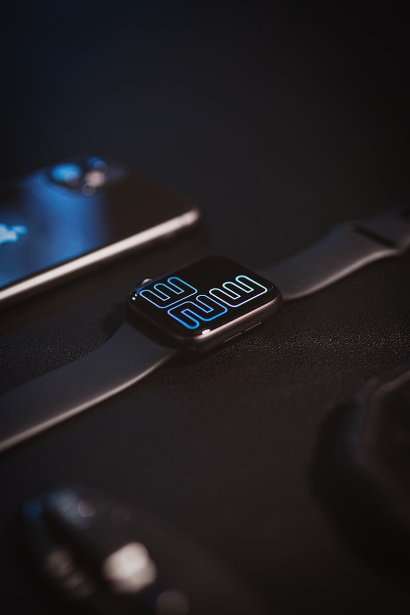 a cell phone sitting next to a smart watch