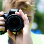 person using black Canon DSLR camera