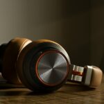 white and black headphones on brown wooden table