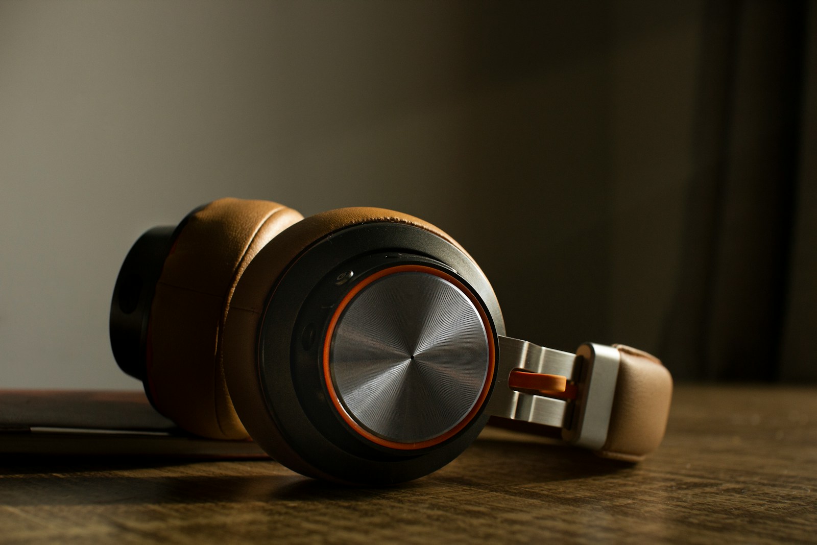 white and black headphones on brown wooden table