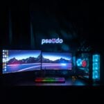 black flat screen computer monitor turned on with black computer keyboard