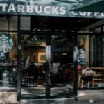 a starbucks coffee shop with a person sitting at a table