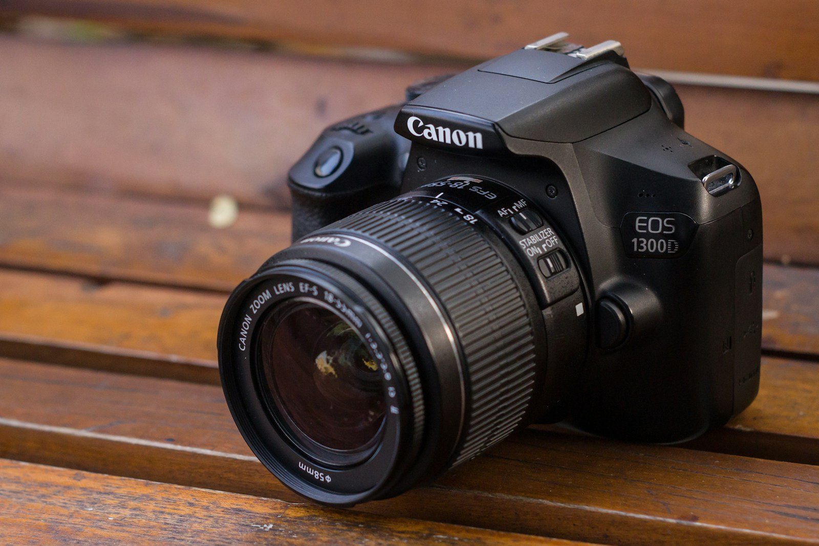 a camera sitting on top of a wooden bench