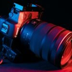 black nikon dslr camera on red textile