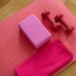 pink dumbbell on pink textile