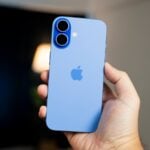 A person holding a blue iPhone in their hand