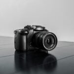 black nikon dslr camera on blue surface