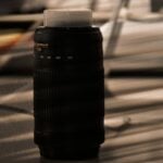 a black cylindrical object on a wooden surface