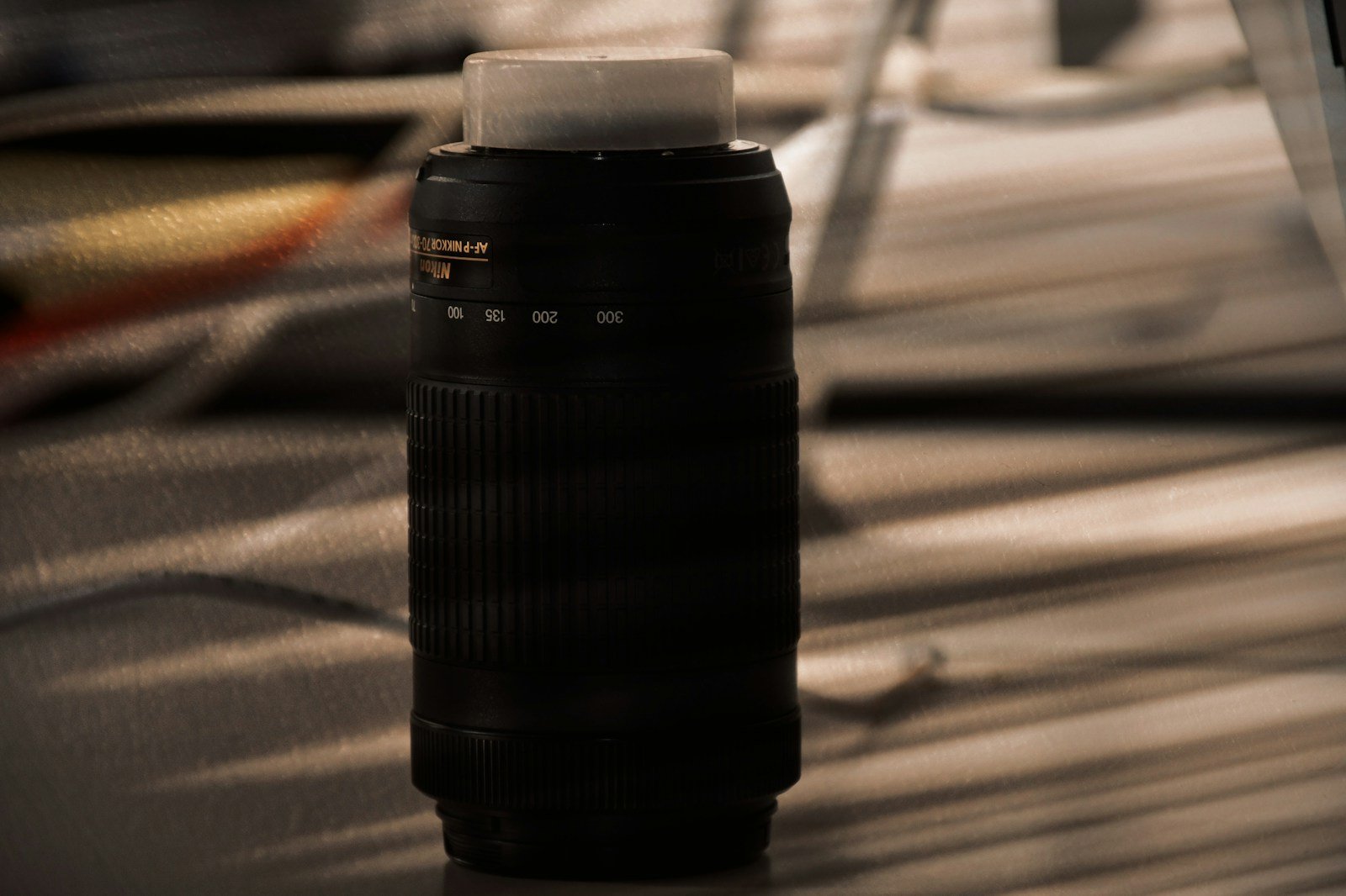 a black cylindrical object on a wooden surface