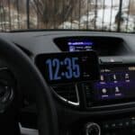 a car dashboard with a digital clock on it