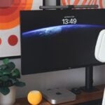 A desk with a computer monitor and keyboard