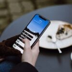 selective focus photography of person using black smartphone