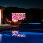 A pool at night with lights reflecting off of the water