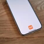 A cell phone sitting on top of a wooden table