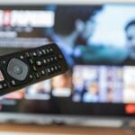 black remote control on brown wooden table