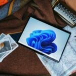 a laptop computer sitting on top of a bed