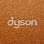 the word dyson written on a brown leather surface
