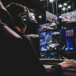 person sitting on gaming chair while playing video game