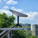 a white surfboard sitting on top of a metal pole