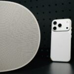 White sonos speaker and iPhone on dark background