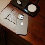 an iphone is sitting on a wooden table