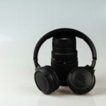 black JBL cordless headphones on black zoom lens
