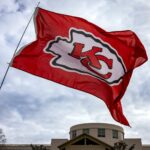 a kansas chiefs flag flying in front of a building