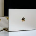a white apple laptop sitting on top of a table