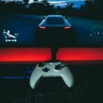 a video game controller sitting in front of a monitor