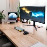 black flat screen computer monitor on brown wooden desk