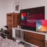 black flat screen tv on brown wooden tv rack