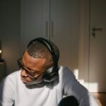 man in white long sleeve shirt wearing black headphones