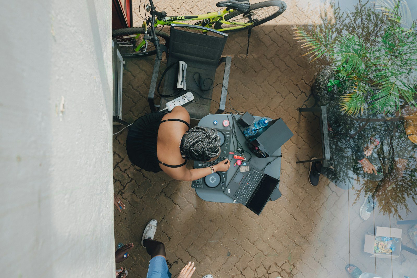 Woman working at a desk with laptop and bicycle.
