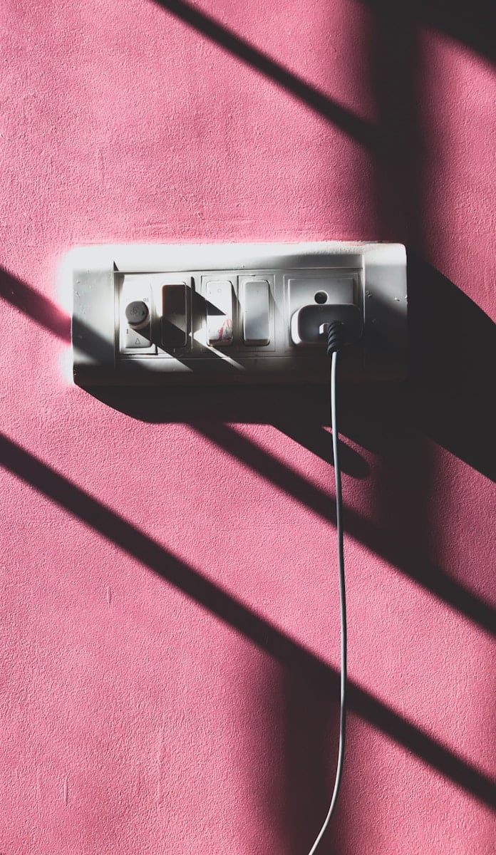 black usb cable plugged in white power outlet