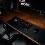 black computer keyboard on brown wooden desk