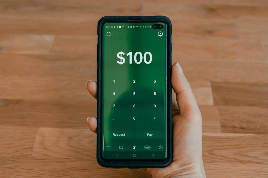 Cash App person holding black android smartphone