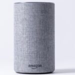 gray jbl portable speaker on white table