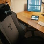 black flat screen computer monitor turned on on brown wooden desk