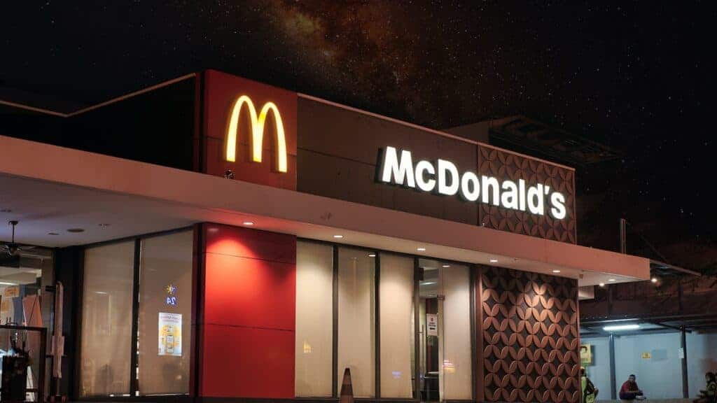 a mcdonald's restaurant is lit up at night