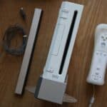 a nintendo wii game system sitting on top of a wooden table