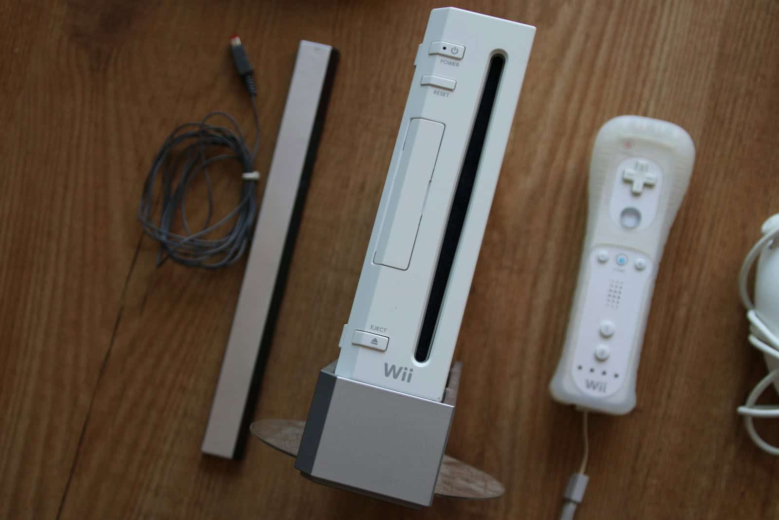 a nintendo wii game system sitting on top of a wooden table